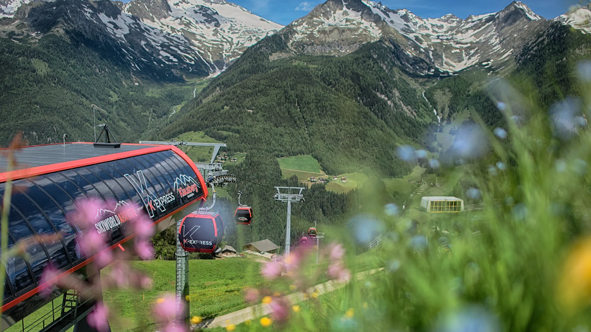 K-Express gondola lift at Klausberg in summer with views of the Zillertal Alps and mountain panorama