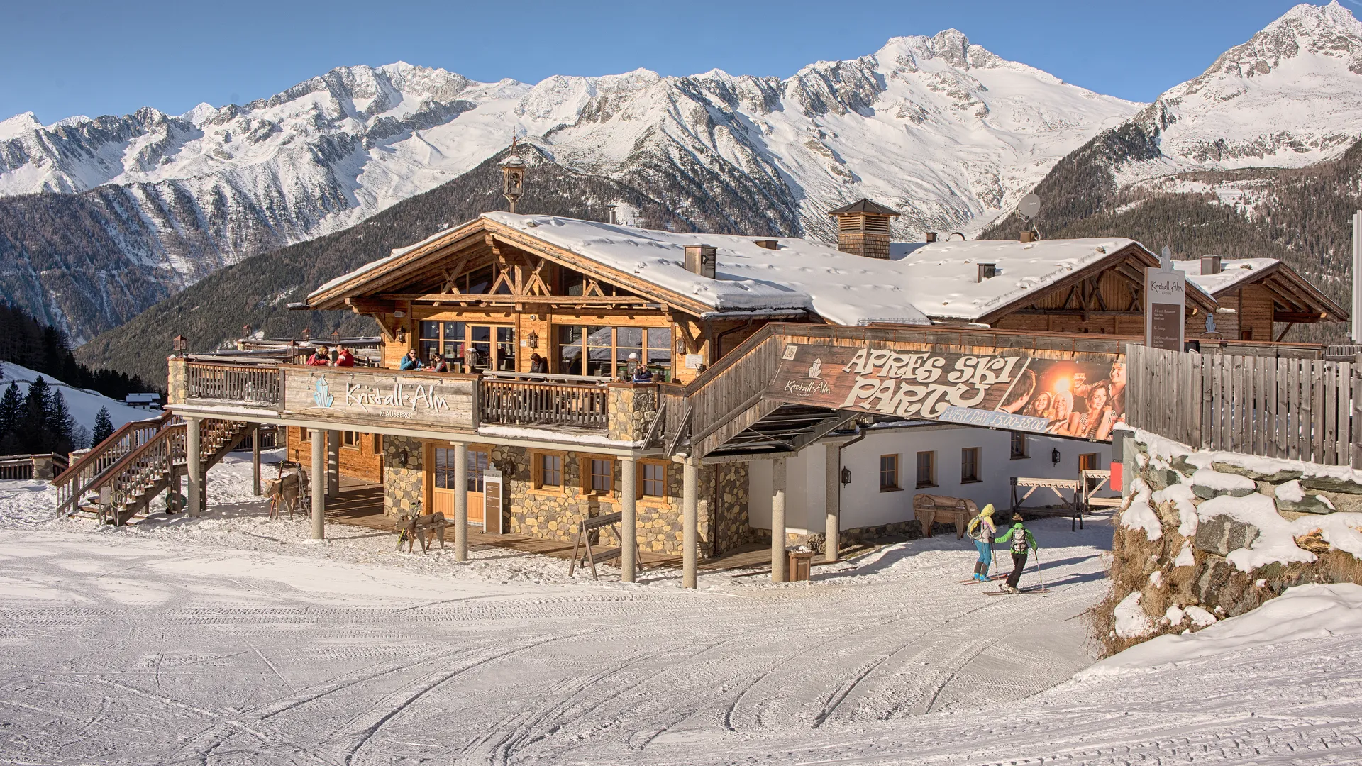 Kristall Alm at Klausberg with sun terrace, skiers and snow-covered mountain panorama