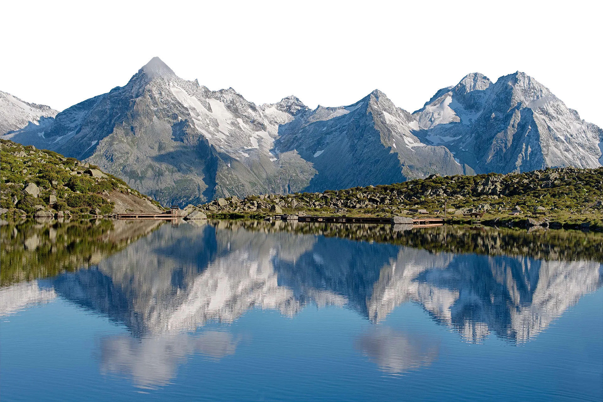 Crystal clear mountain lake with reflection of the Zillertal Alps at Klausberg