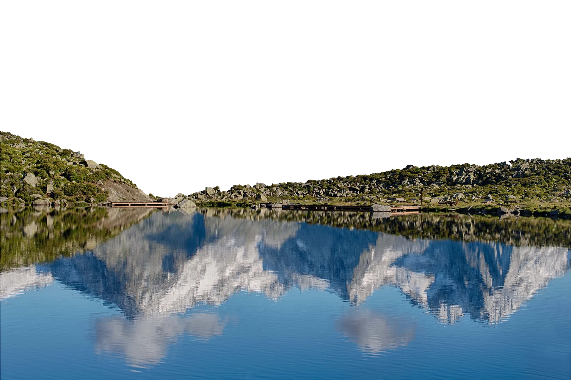 Reflection of the Zillertal Alps in clear mountain lake at Klausberg in Ahrntal
