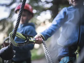 Carabiner on via ferrata steel cable — children climbing at Speikboden