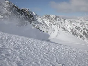 Freerider in deep powder snow with panoramic view of snowy peaks at Klausberg Ahrntal