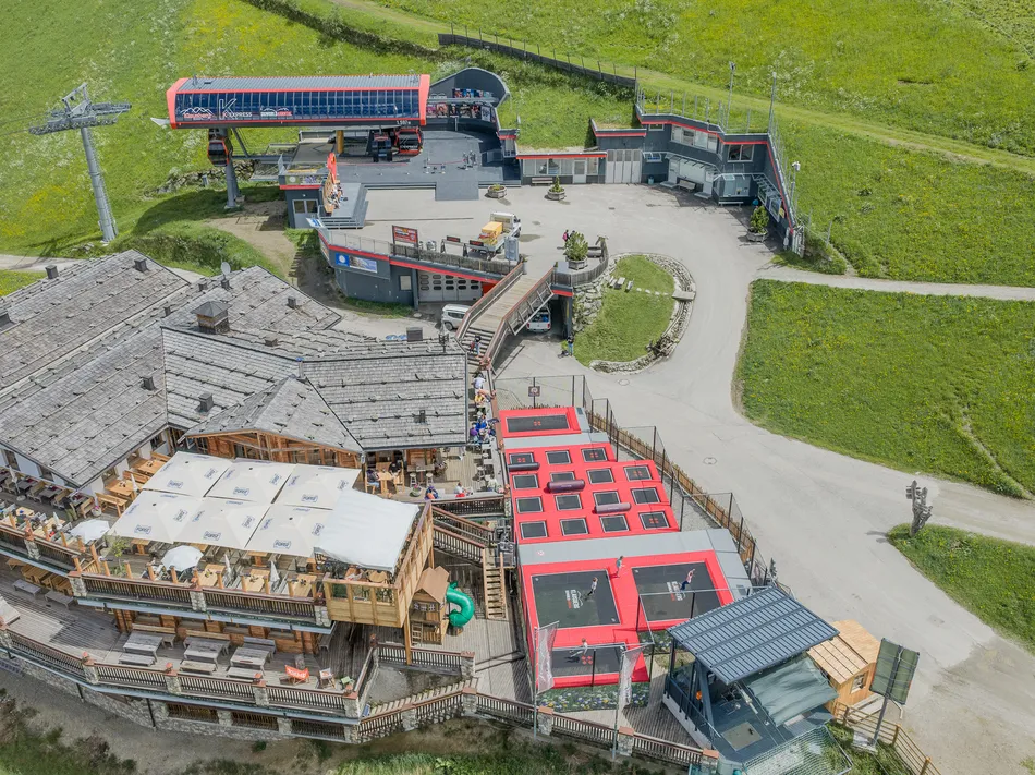 Mountain station of K-Express on Klausberg with alpine hut, sun terrace and trampoline park in summer
